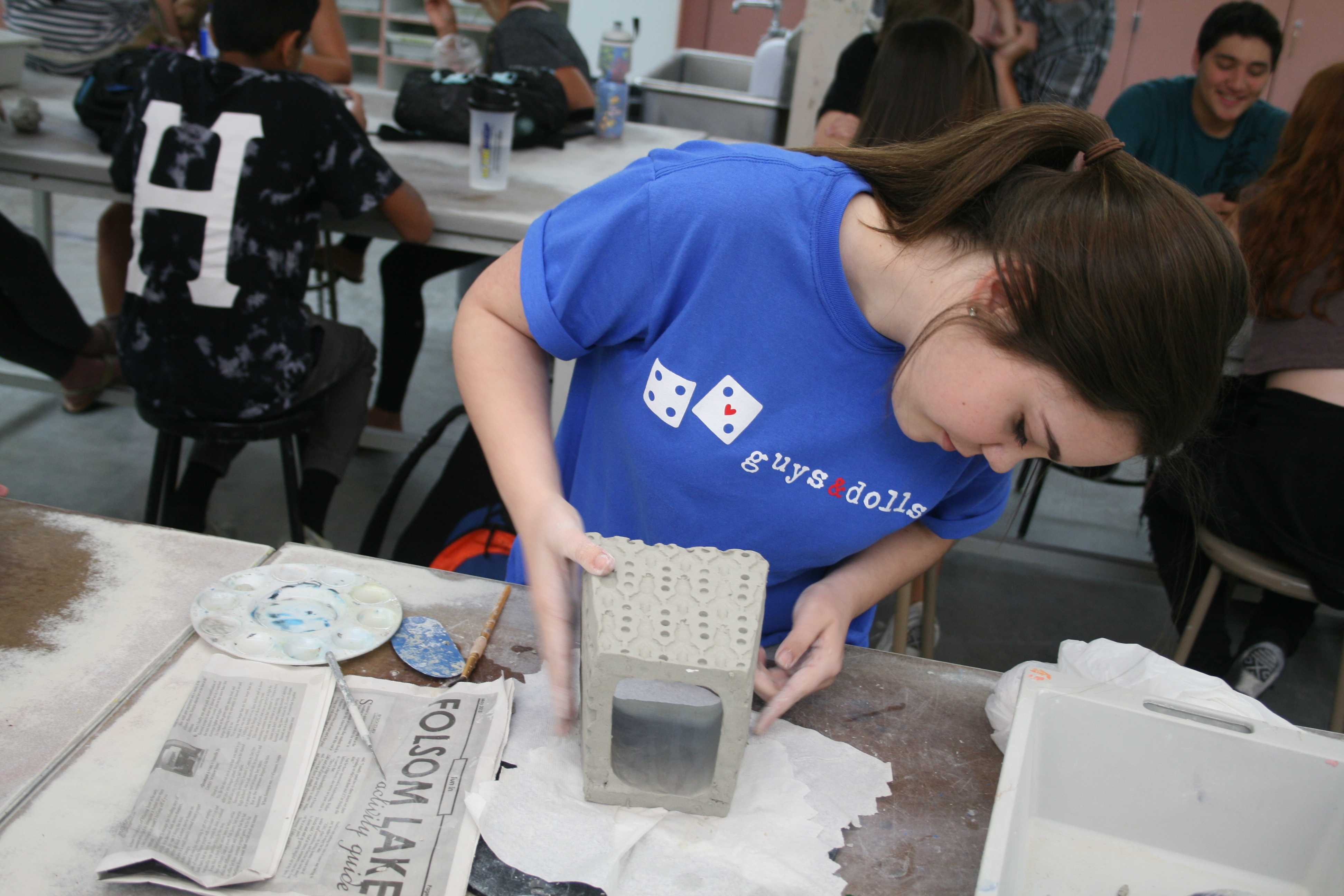 In Mr. Ron Owens ceramics class, junior Bailey Bradford smooths out the edges of her box. Bradford wanted to make it look nice since she will have it for a long time. “I take as much time as I need so I can get my best quality work,” Bradford said. Photo by Nishita Fernandes