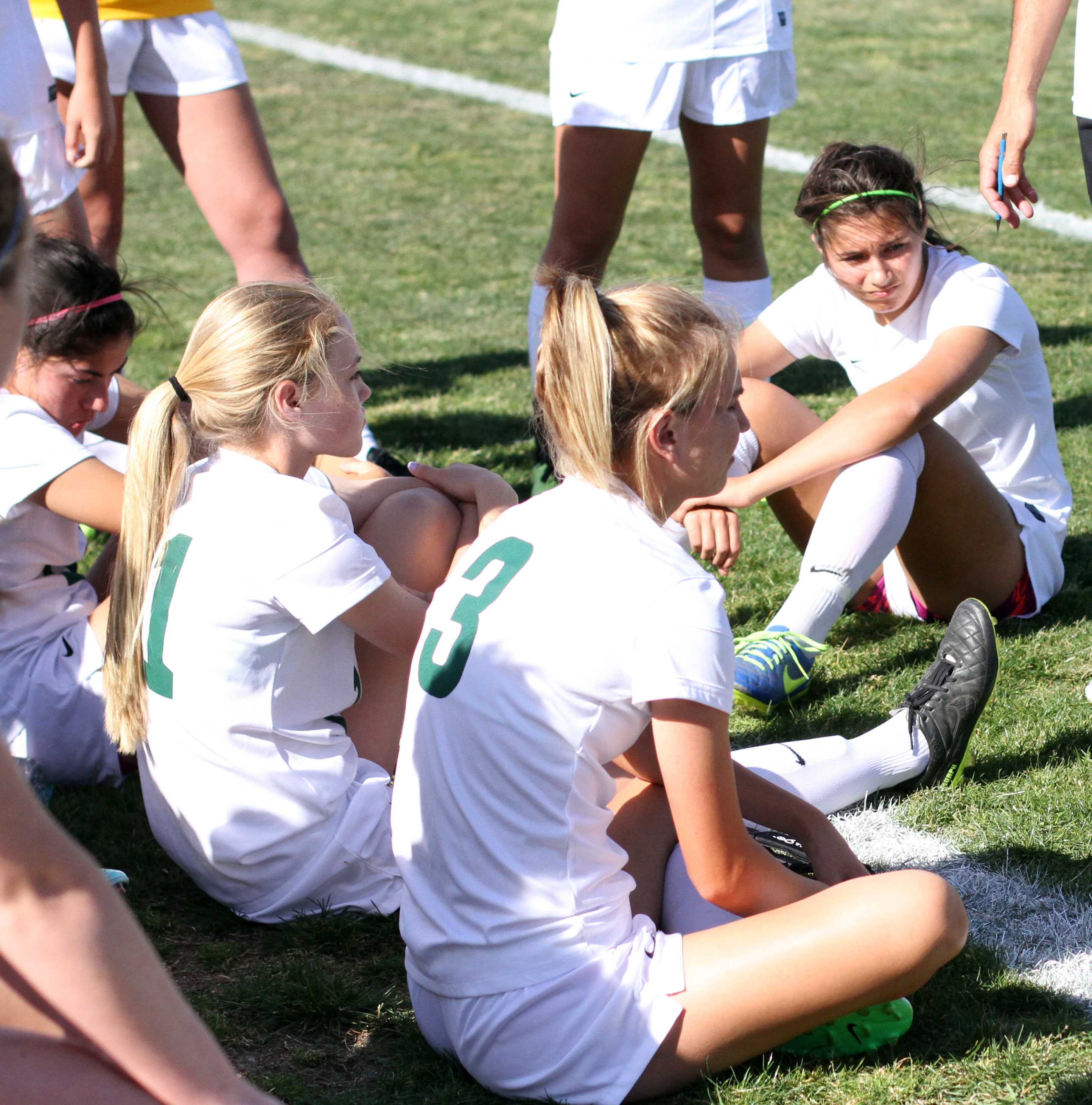 Along with some of the Girl’s Varsity Soccer team, freshman Isabella Perez sits on the floor during a time-out against Folsom. 20 minutes before the game ending with a tie of 1:1, their coach brings them all together to tell them strategies and encouragements for them to play diligently for the remaining time left. “I must have determination when the game is about to end. I always try to leave it out on the field even if I am tired,” Perez said. Photo by David Goni