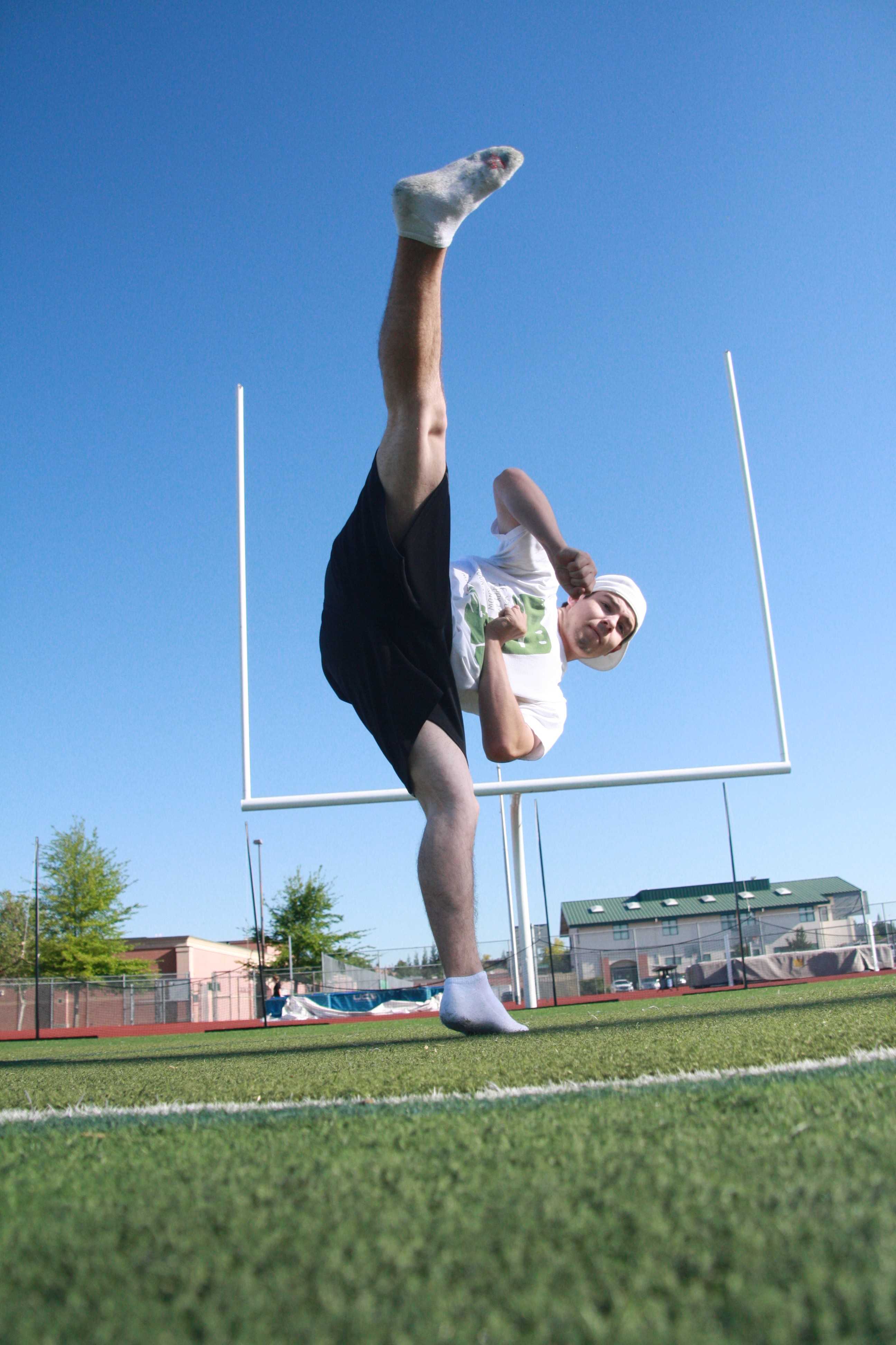 To kick senior Luke Molina is working on his spin hook kick before school on April 16. He is striving to become a pro athlete in an underground sport called tricking. If we wants to get better that means he has to constantly work on his basics. “I can always work on the harder flips and kicks but they will look very bad and sloppy if I do not work on my basics all the time,”  Molina said. Photo by Dillon Wilder