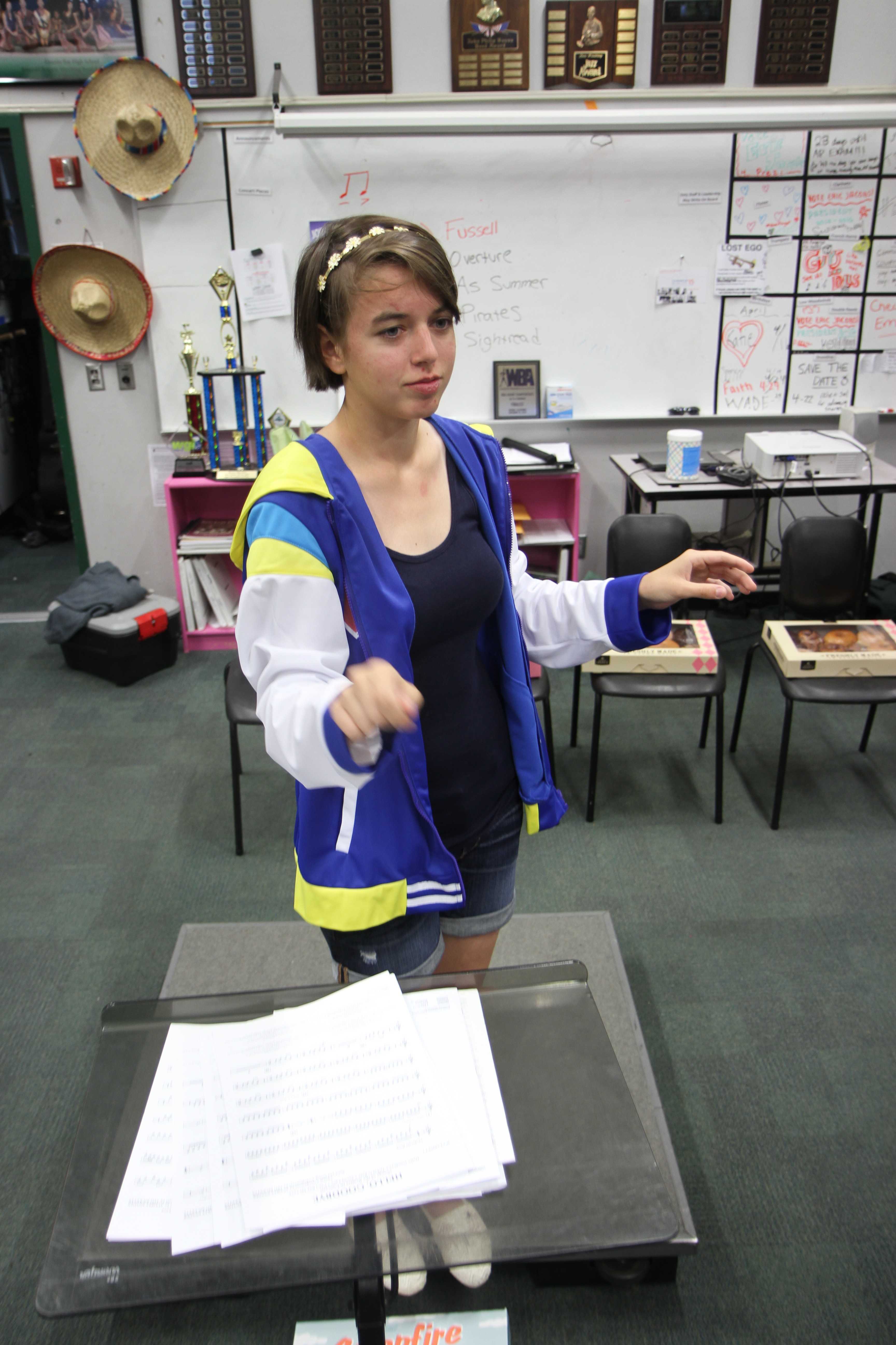 In Mrs. Lynn Lewis’ first period symphonic band, Junior Emalyn Atkins directs the freshman class, preparing for the spring concert and the disneyland tour. Their concert at disney includes performing by Big Thunder Mountain and a recording session just for disney music. For the spring concert they are playing a beatles medley, Overture in B flat, and a Pirates of the Caribbean Medley. “ Whenever we run anything I am always listening to how we can get better and what we really need to work on and basically how can I help the band get better,” Atkins said. Photo by Janelle Cruz