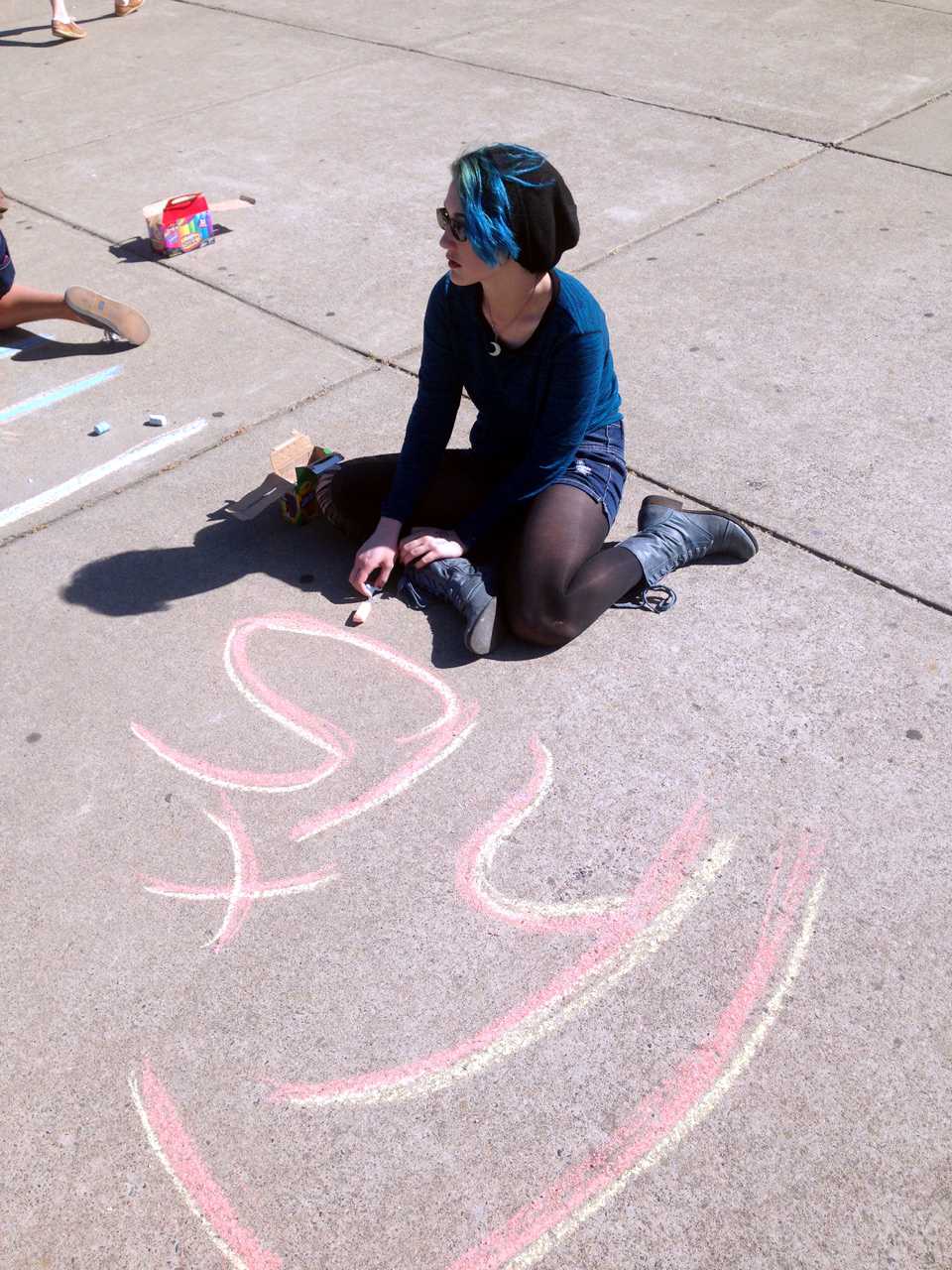 To announce the Day of Silence taking place on April 17, sophomore Megan Gallant writes information in the quad using chalk after school. The Day of Silence is a national student led event that illustrates the silencing effect of bullying. “Day of Silence has been going on here for at least 4 years. It’s been a way to bring awareness to the injustices done to the LGBT community.” GSA club co-vice president senior TJ Conway said. Photo by Kristen Goldman