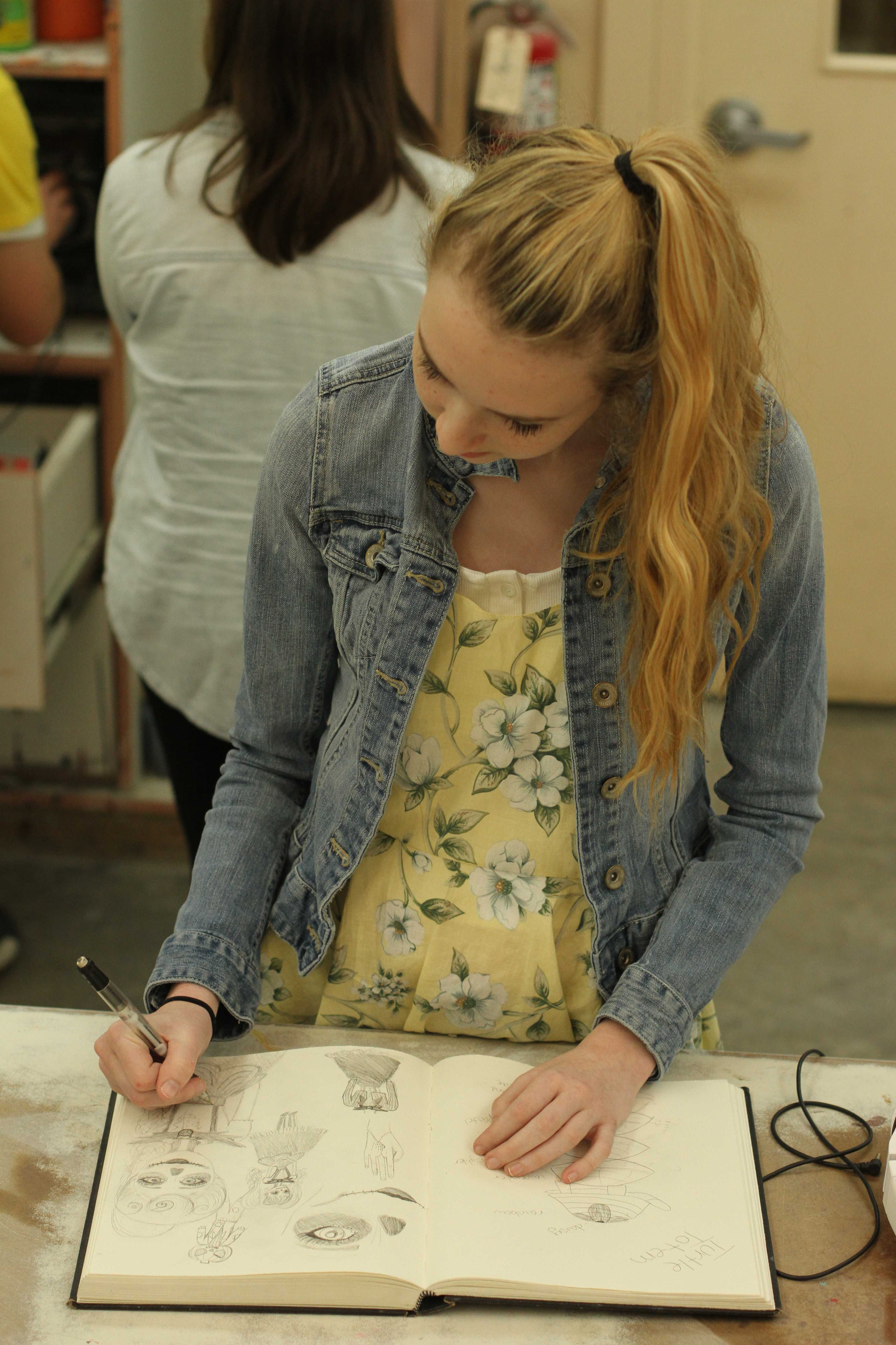 In Mr. Brad Cordell’s Ceramics class third period, sophomore Cassie Hamilton a design for her cosplay draws in her sketchbook. Hamilton planned on attending SacAnime, a smaller, more local version of Comic Con, September 4-6 in a gender bent Jack Skeleton. “Sewing is pretty difficult but I enjoy that you get to create your own clothes,” Hamilton said. Photo by Nicole Svistun