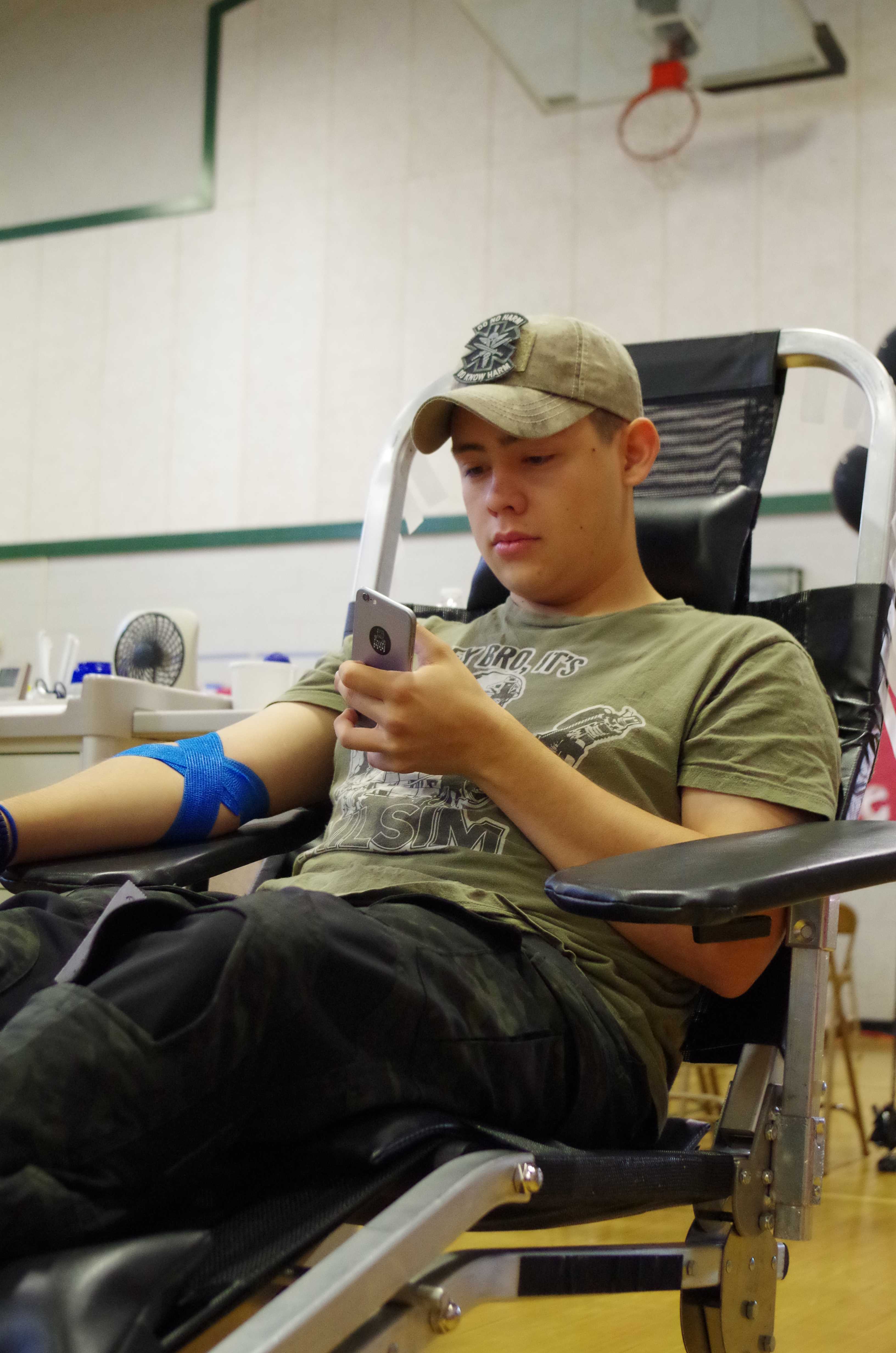 BLOOD CRAZE: If junior Chris Ramirez hadn’t had the acceptable temperature, iron levels, and various other requirements he wouldn’t have been able to donate blood on May 23. Blood Source comes twice a year to get students and teachers to volunteer to donate and possibly save a life. “This is the fourth time that I’ve given blood.” Ramirez said. Photo by Kristen Goldman
