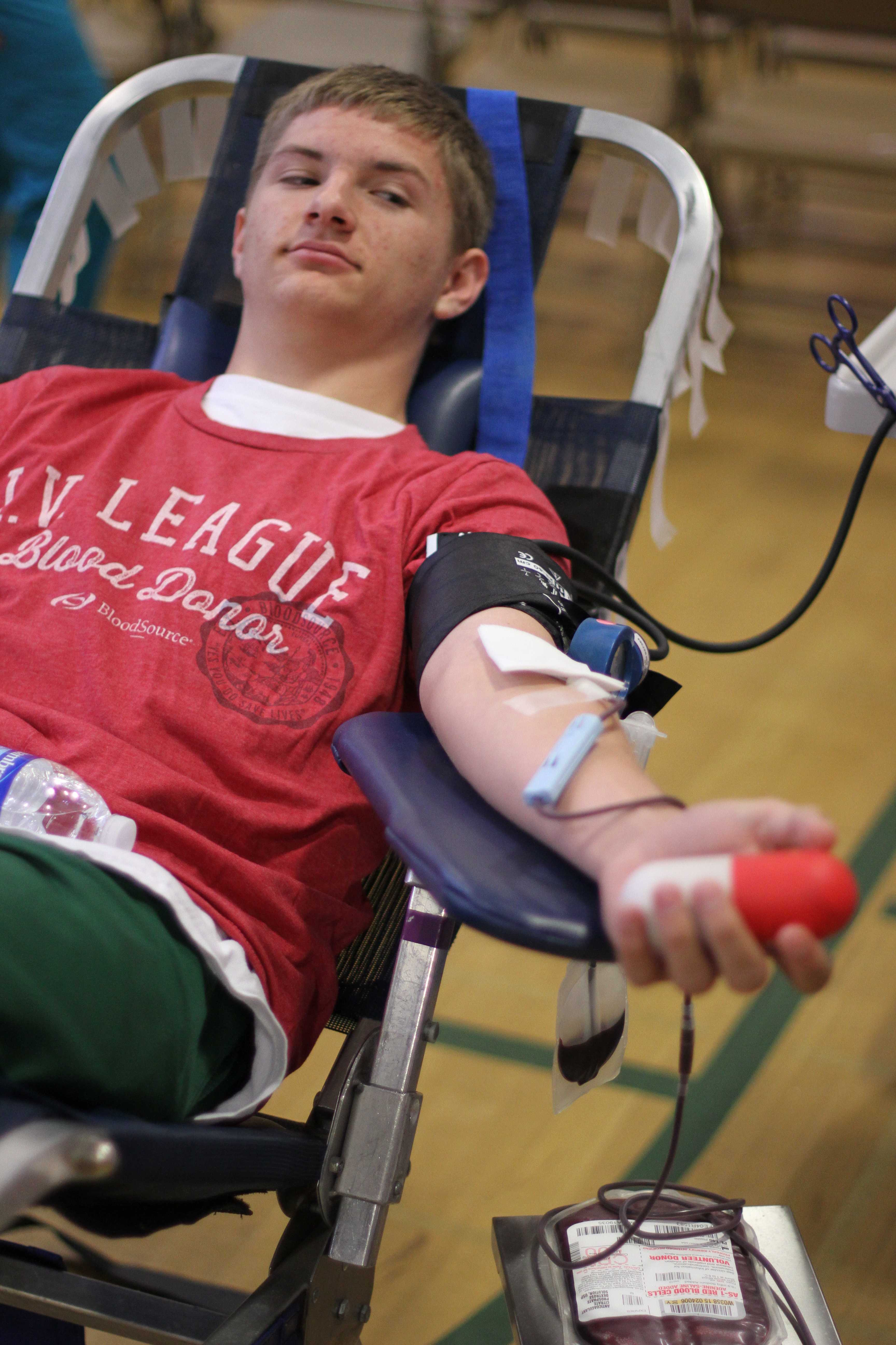 FLOWING BLOOD: Although sophomore William Torres feels like he has not done many good deeds, on April 23, he donated blood to BloodSource. The stress ball in his left hand was used to help keep the blood flowing into the bag by moving it around. “I just wanted to do something good to help other people,” Torres said. Photo by Nicole Svistun