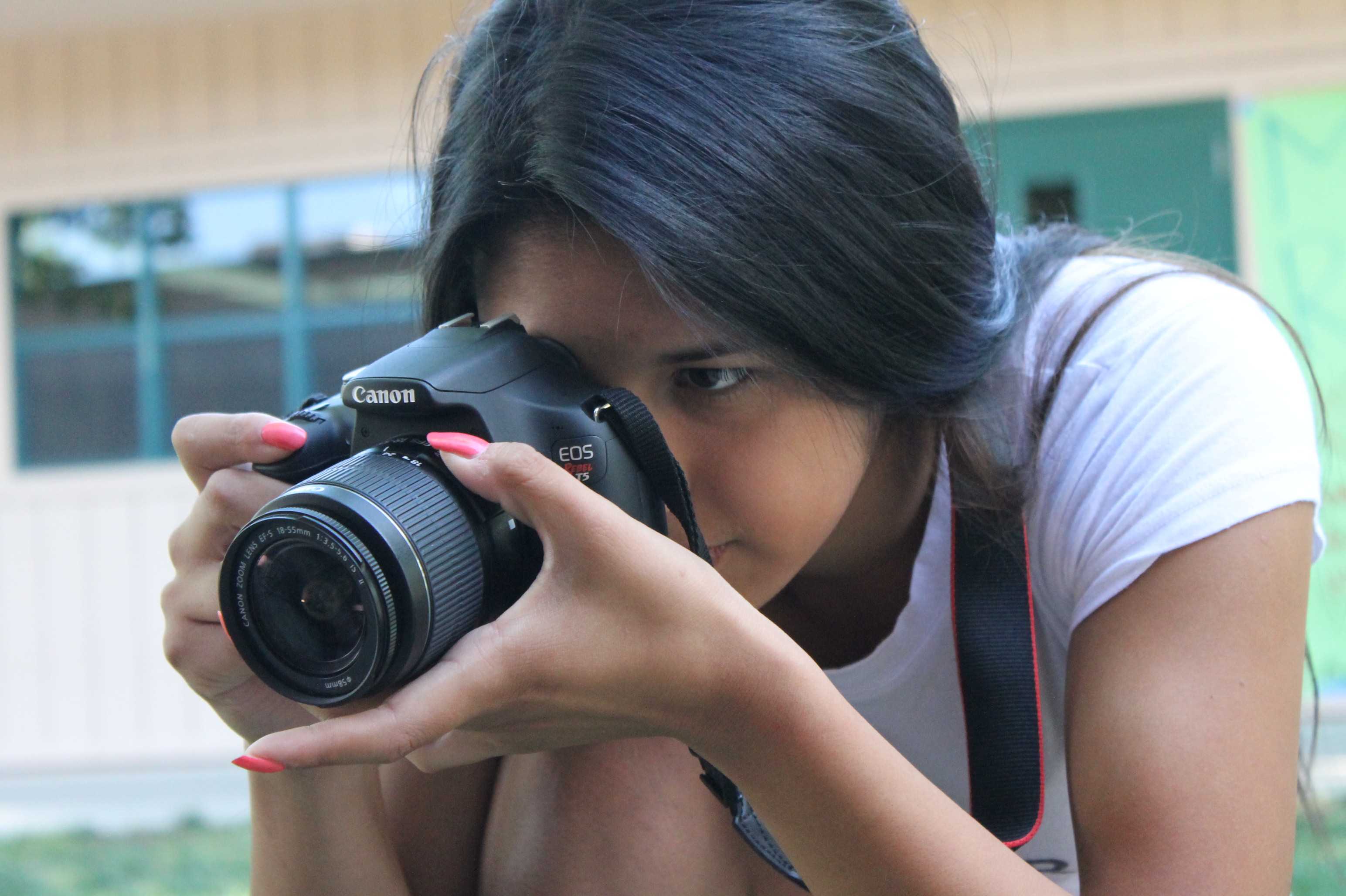 CAPTURE IT ALL: Since her photography project is due, sophomore Leah Thomas takes photos during her first period class on April 27. “You can be creative of what you can do and follow the strict rules of taking photos,” said Thomas. Photo by Chia Vang