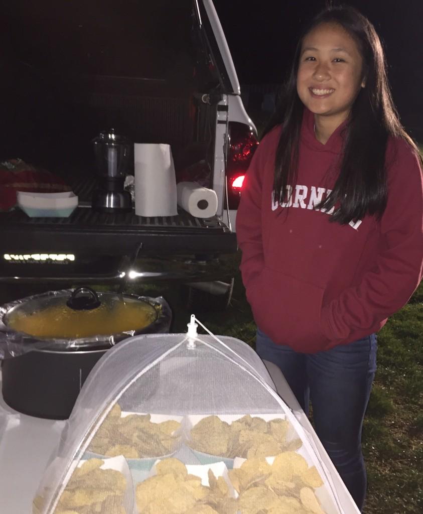 Freshman Ashley Yung sells cheesy nachos at the Bonfire Rally in order to raise money for Key Club.