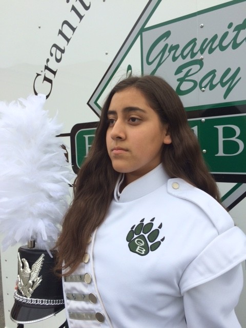 In a traditional performance outfit, Freshman Elizabeth Loya poses in front of the trailers containing the band gear the Monday after Homecoming.