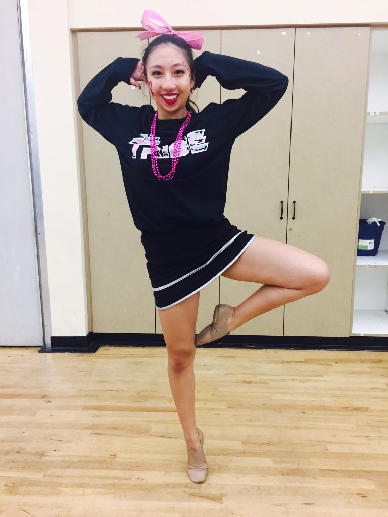 Wearing pink for breast cancer awareness, senior Extreme Dance Team member Kiana Abrigana strikes a pose before the Homecoming game.